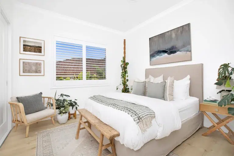 Hardwood shutters in a bedroom providing privacy.