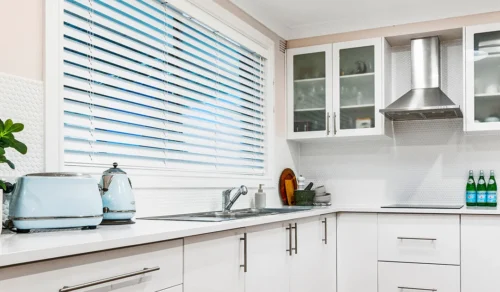 Timber venetian blinds work beautifully in the kitchen.